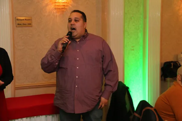 Local 3005 member singing at the 2019 holiday party
