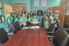 Local 3005 Member during their lobby day holding green signs and wearing green shirts